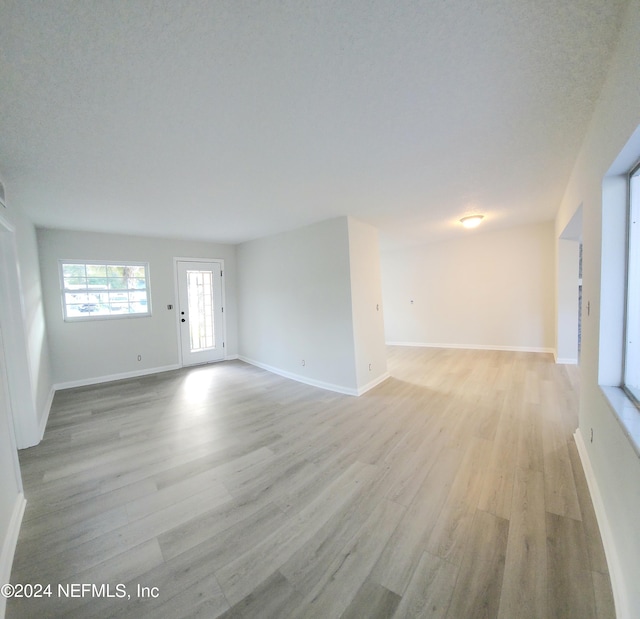 unfurnished living room featuring light hardwood / wood-style floors