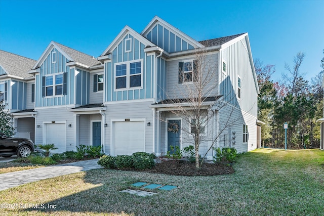 view of front of property with a front lawn, board and batten siding, an attached garage, and decorative driveway