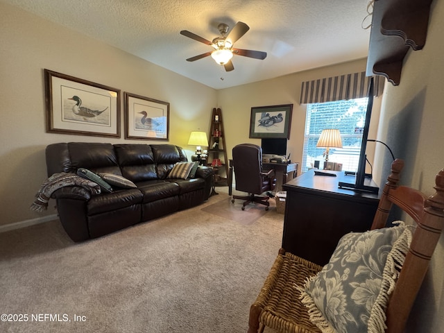 carpeted office with ceiling fan, a textured ceiling, and baseboards