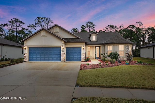 view of front of property with a garage, stone siding, a yard, concrete driveway, and stucco siding