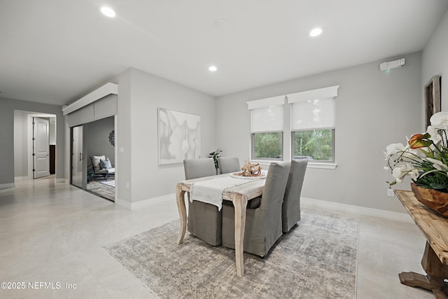 dining room with baseboards and recessed lighting