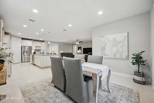 dining room featuring light tile patterned floors, baseboards, visible vents, a ceiling fan, and recessed lighting