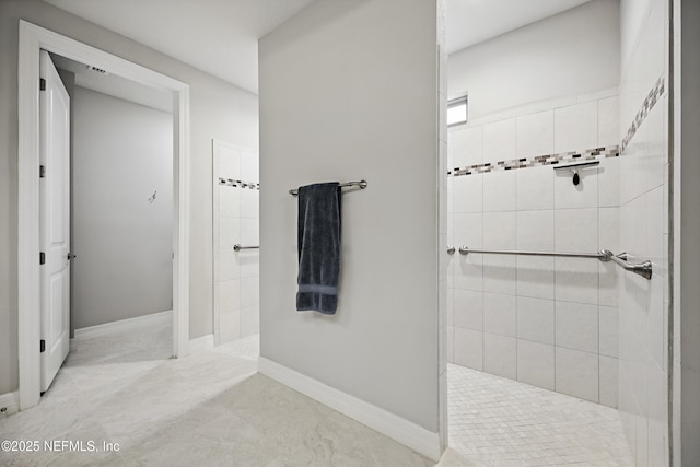 full bathroom featuring walk in shower and baseboards