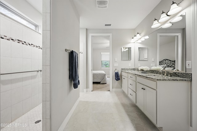 bathroom featuring ensuite bathroom, visible vents, a sink, and a wealth of natural light