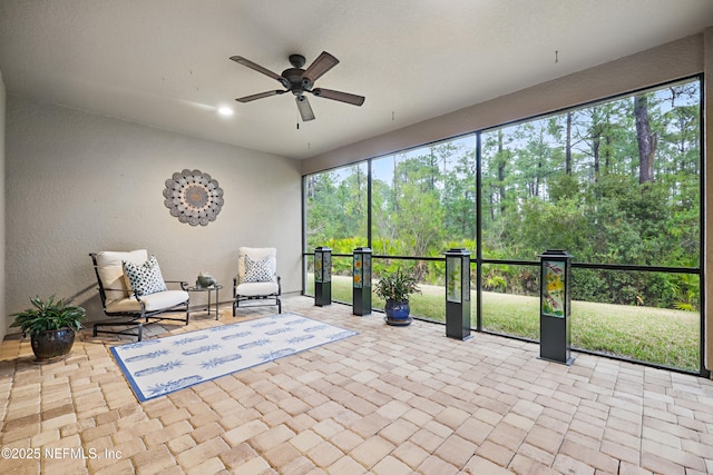 unfurnished sunroom featuring a ceiling fan