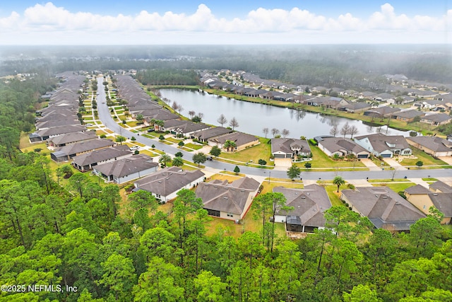 drone / aerial view with a water view and a residential view