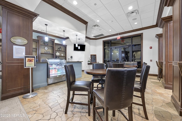 dining room with ornamental molding, stone finish floor, visible vents, and baseboards