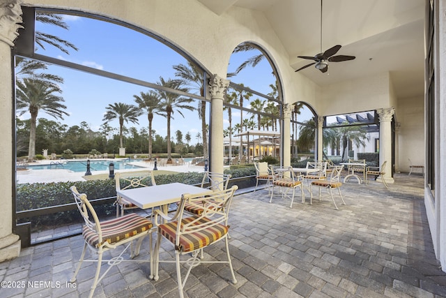 view of patio / terrace with a ceiling fan, outdoor dining space, and a community pool