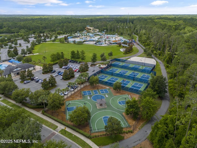 bird's eye view with a wooded view