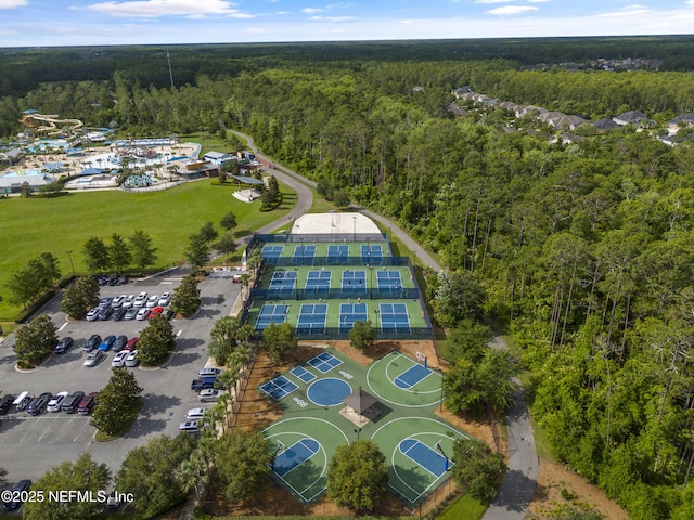 drone / aerial view featuring a wooded view