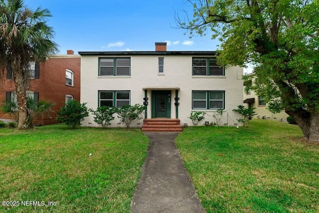 view of front facade with crawl space, stucco siding, a chimney, and a front lawn