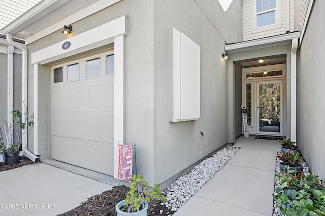 entrance to property with stucco siding