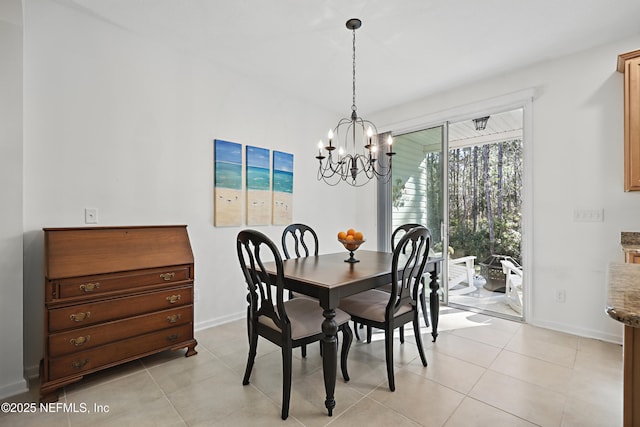 dining area with baseboards, a notable chandelier, and light tile patterned flooring