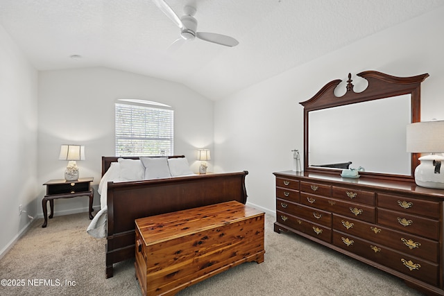 bedroom with lofted ceiling, ceiling fan, a textured ceiling, light carpet, and baseboards