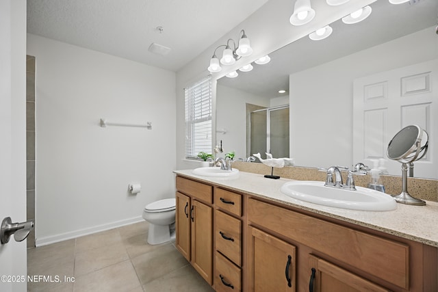 full bath with double vanity, tile patterned flooring, a sink, and a shower stall