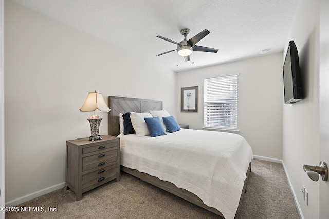 bedroom with a ceiling fan, carpet flooring, and baseboards