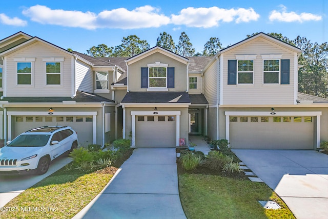 traditional-style home with driveway, an attached garage, and stucco siding