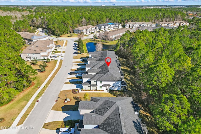 bird's eye view with a residential view and a wooded view