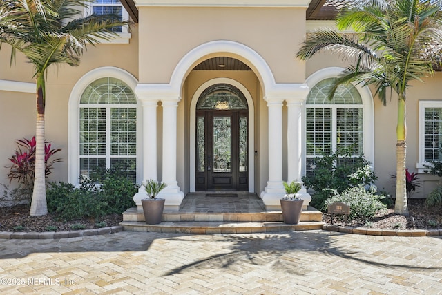 property entrance with stucco siding