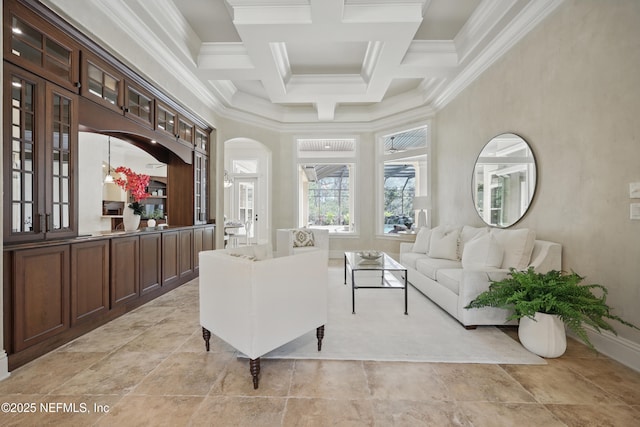 sitting room with a towering ceiling, crown molding, coffered ceiling, and beam ceiling