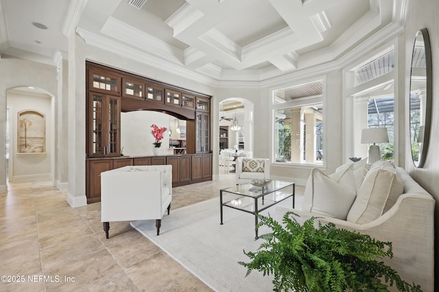 interior space featuring arched walkways, coffered ceiling, crown molding, and beamed ceiling