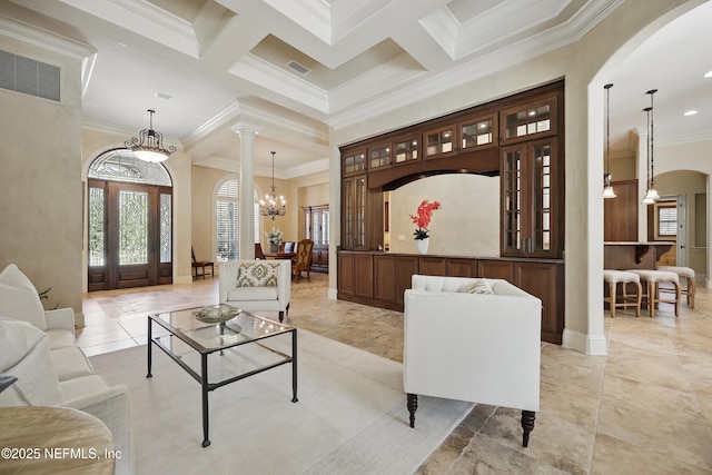 interior space featuring a chandelier, arched walkways, visible vents, and crown molding