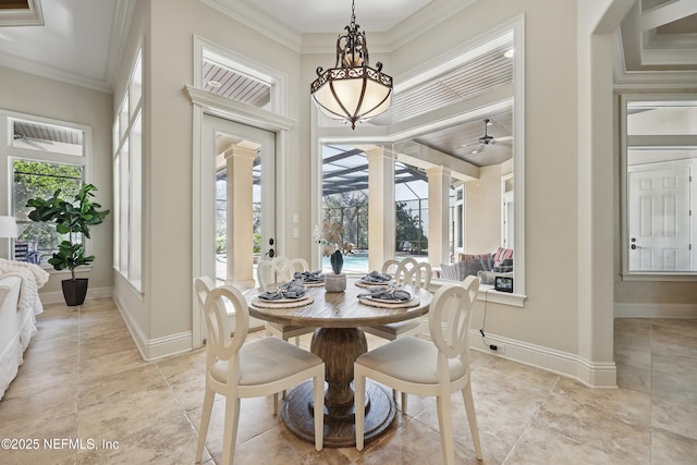 dining room featuring ornate columns, ceiling fan, baseboards, and crown molding