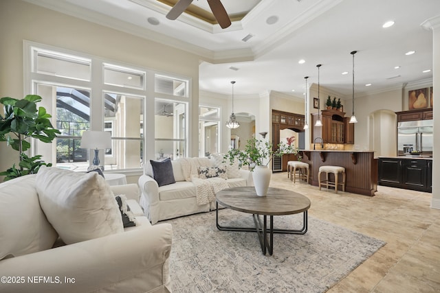 living room featuring visible vents, a towering ceiling, a ceiling fan, and crown molding