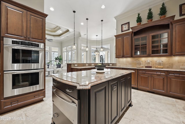 kitchen featuring double oven, a healthy amount of sunlight, ornamental molding, and tasteful backsplash