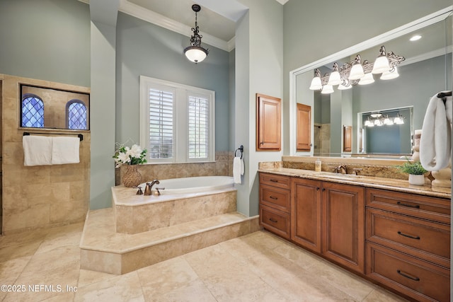 bathroom featuring a bath, ornamental molding, a tile shower, and vanity