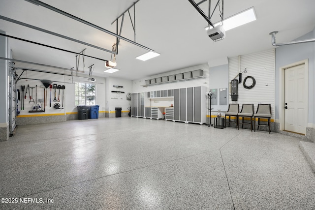 garage with baseboards and a garage door opener