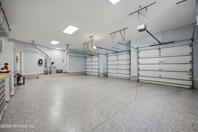 garage featuring a garage door opener, gas water heater, and baseboards