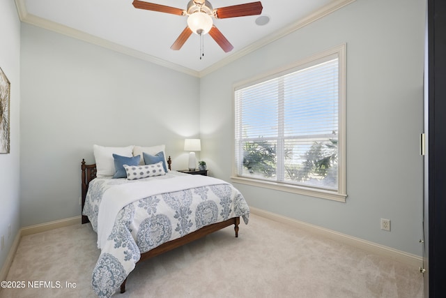 bedroom with a ceiling fan, baseboards, crown molding, and carpet flooring