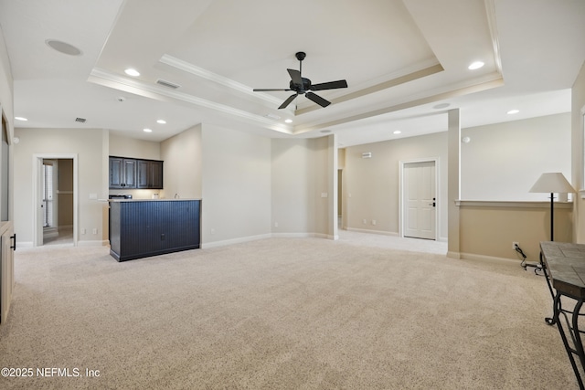 unfurnished living room featuring recessed lighting, light colored carpet, visible vents, baseboards, and a tray ceiling