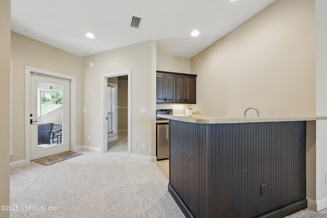 kitchen featuring light colored carpet, visible vents, light countertops, dark brown cabinets, and dishwasher