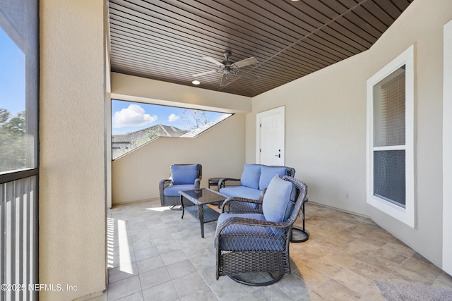 view of patio with an outdoor living space and a ceiling fan