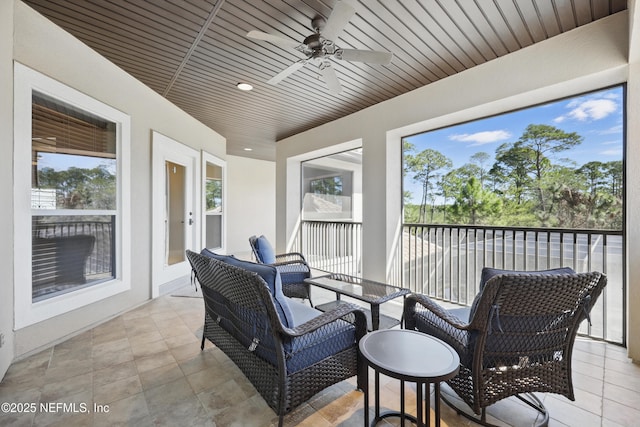 sunroom / solarium featuring wooden ceiling and a ceiling fan