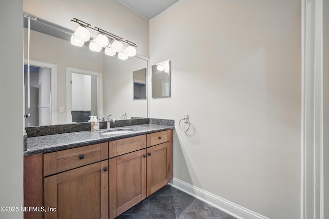 bathroom with tile patterned flooring, vanity, and baseboards