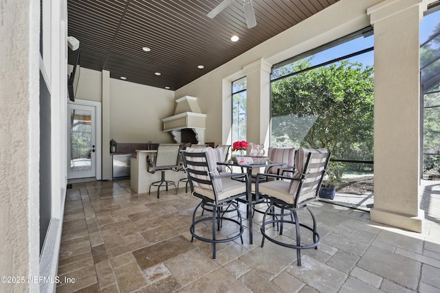 dining space with wood ceiling, stone tile floors, a ceiling fan, and recessed lighting