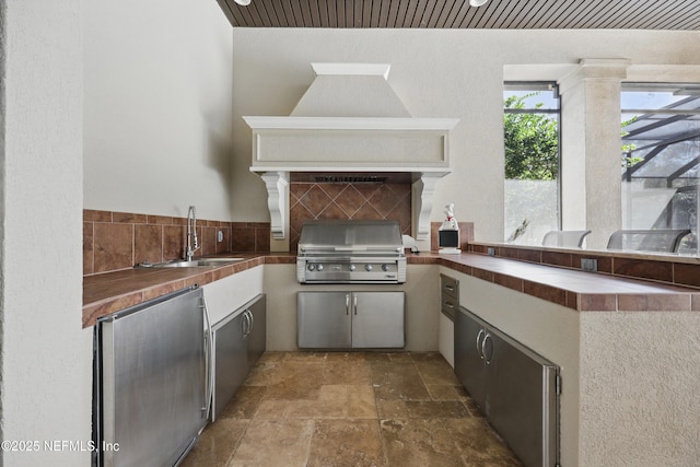 view of patio / terrace featuring a sink, an outdoor kitchen, and area for grilling