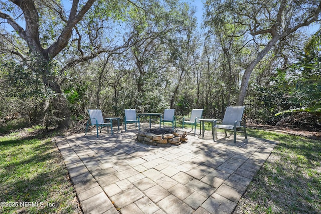 view of patio with an outdoor fire pit and fence