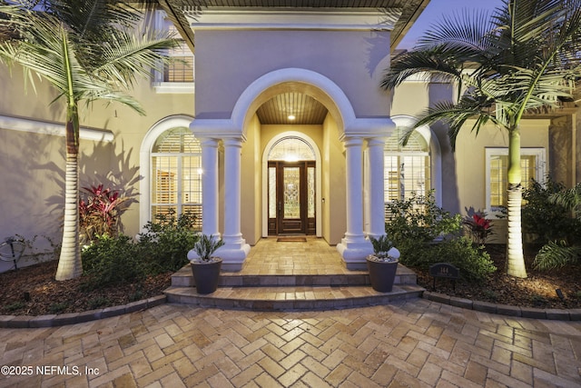 property entrance with stucco siding