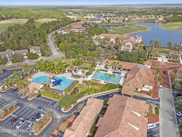 drone / aerial view featuring view of golf course and a water view