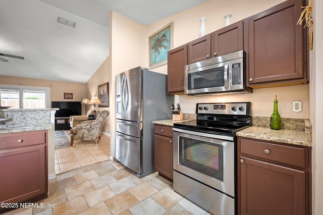 kitchen featuring ceiling fan, sink, stainless steel appliances, and vaulted ceiling