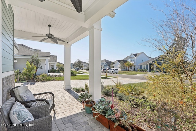 view of patio with ceiling fan and a residential view