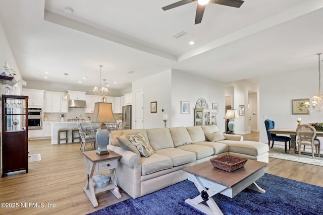 living area featuring recessed lighting, visible vents, and light wood-style flooring