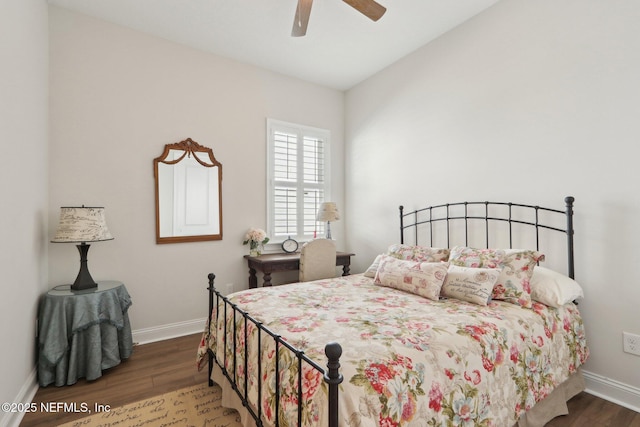 bedroom with dark wood-style floors, ceiling fan, and baseboards