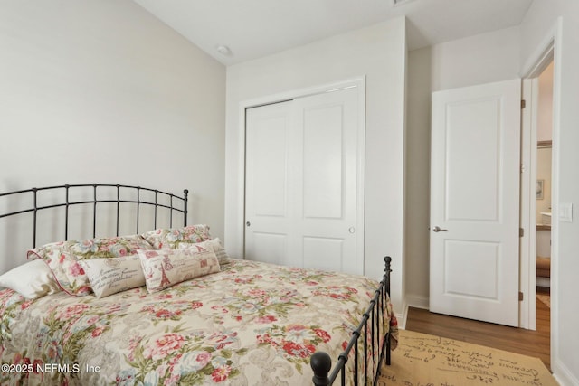 bedroom with a closet and wood finished floors