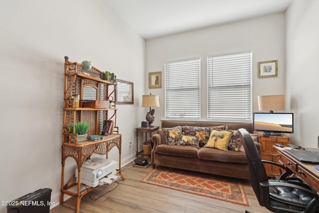 home office with light wood-style floors and baseboards