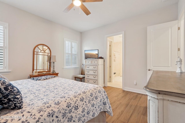 bedroom with light wood-type flooring, baseboards, a ceiling fan, and ensuite bathroom